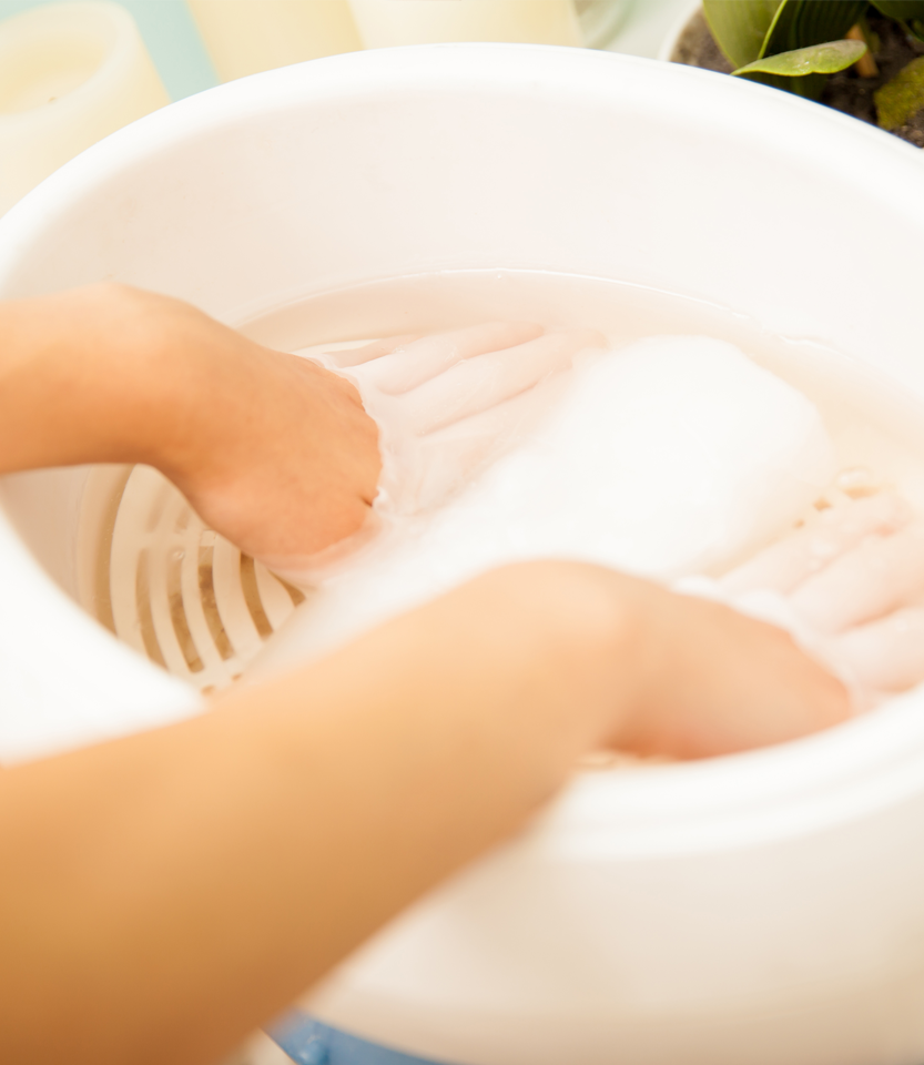 Closeup hands woman dipping her hands moisturizing wax beauty spa